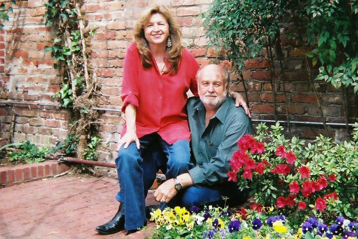 Photo of the author, Norma Cape, and her husband in a garden.